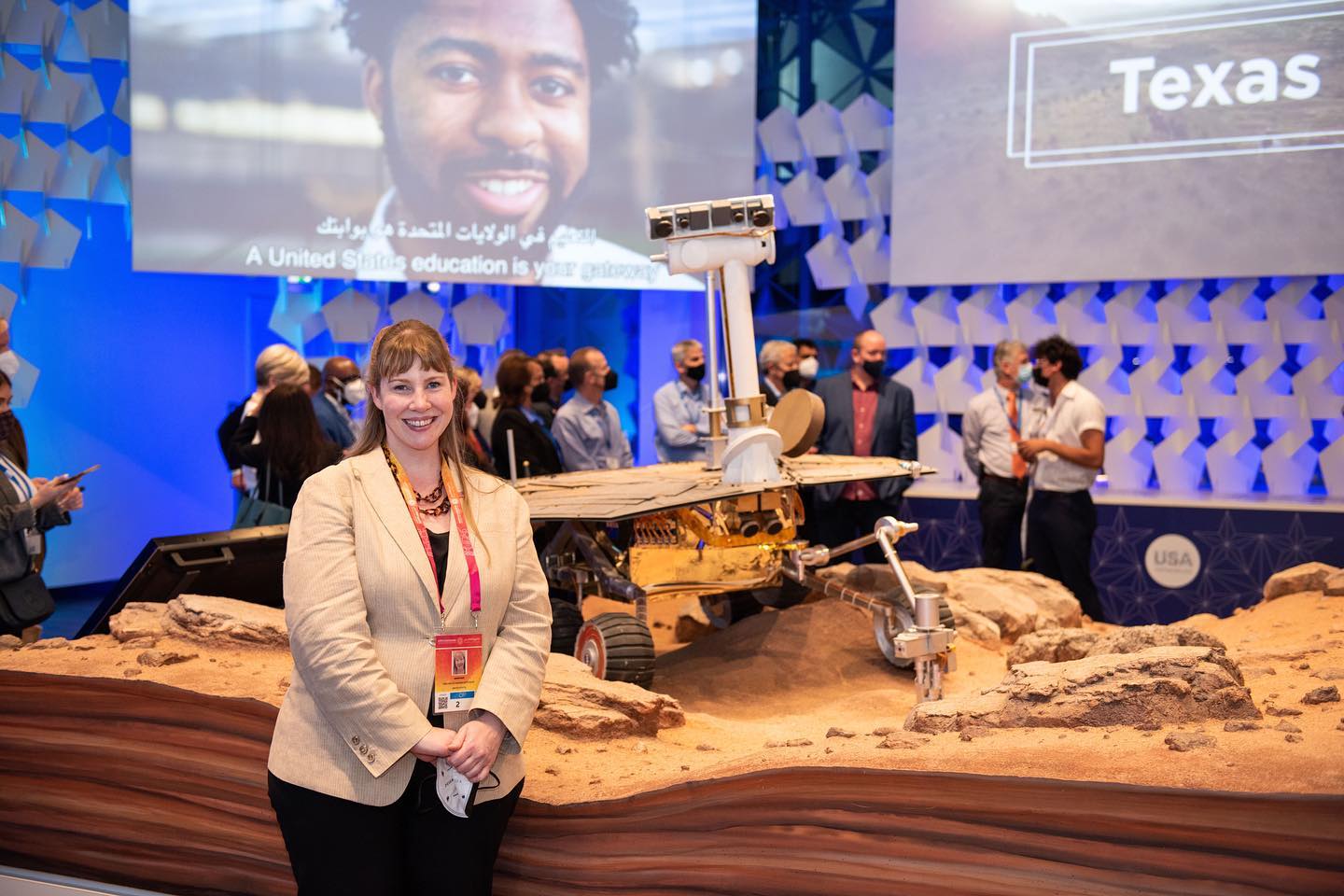 a women stand behind Mars testing Robot Machine 