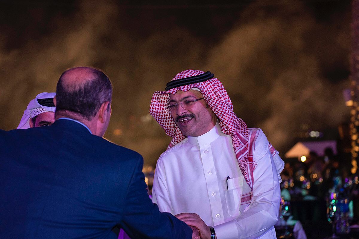 An arab sheikh greetings and receiving guests in a night event