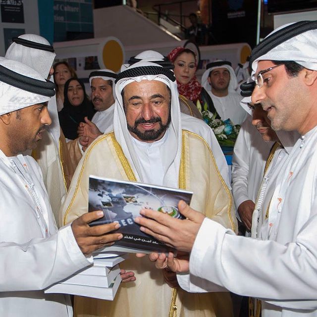 An Arab Leader watching an Image of the Magazine in an Event